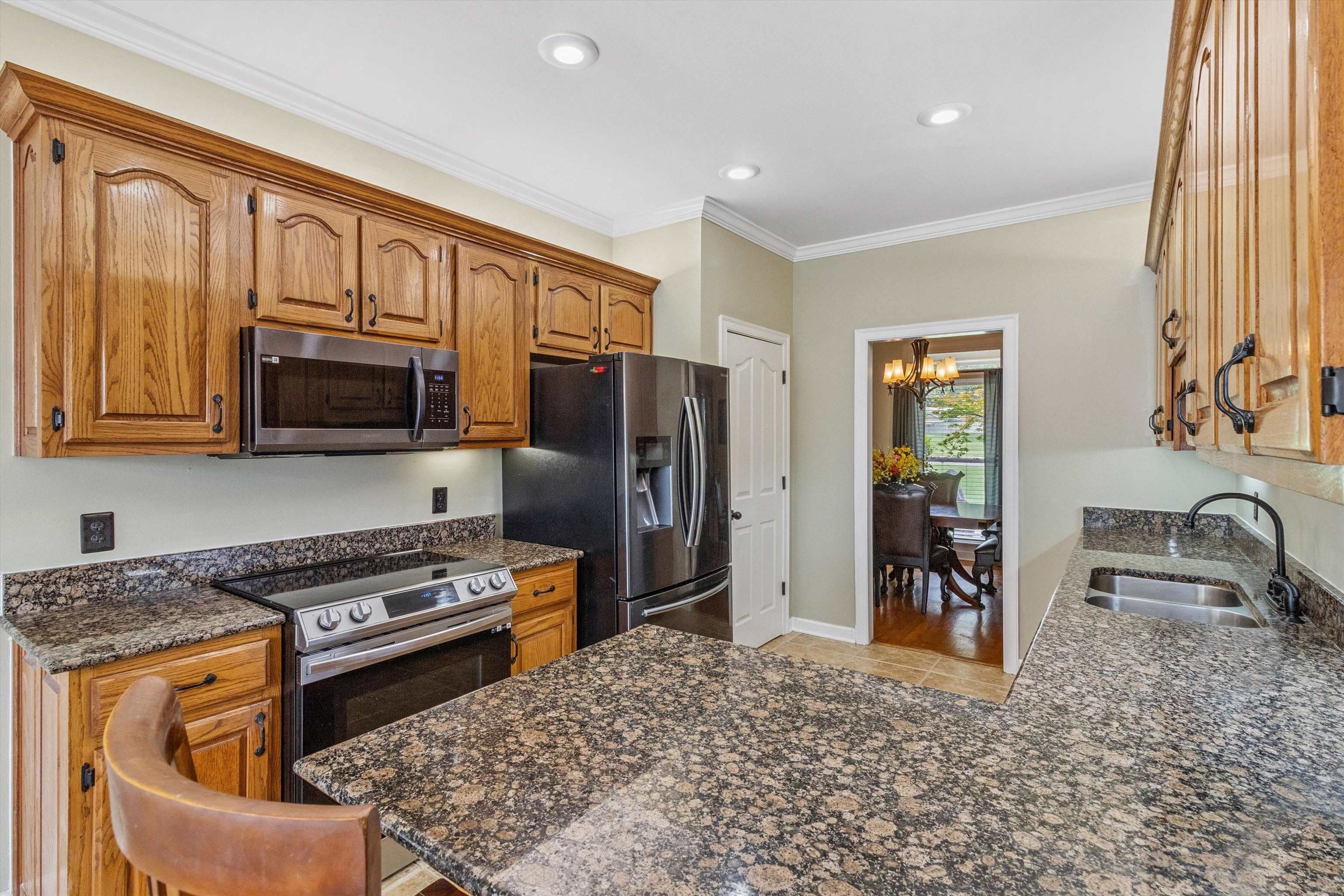 683 Fletcher Road Collierville, TN 38017 - Photo 12 of 30 a kitchen with stainless steel appliances granite countertop a refrigerator stove and sink