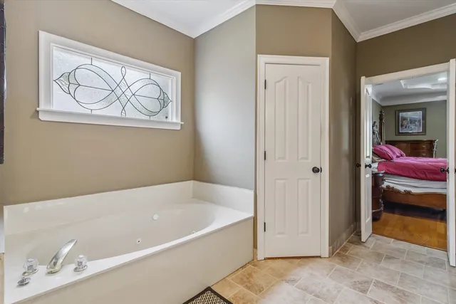a bathroom with a tub and a shower