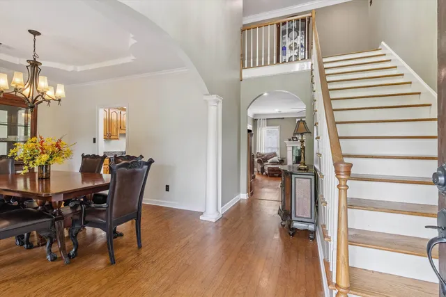 a view of a dining room with furniture wooden floor and chandelier