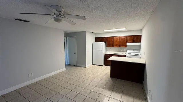 a view of kitchen with stainless steel appliances a refrigerator and a sink