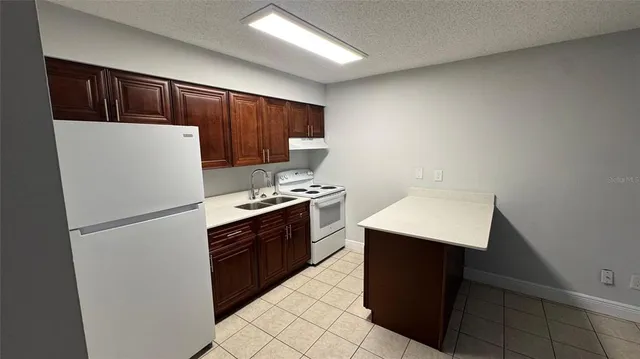 a white refrigerator freezer sitting inside of a kitchen