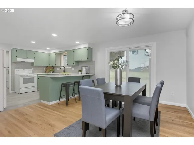 a dining room with kitchen island a table and chairs