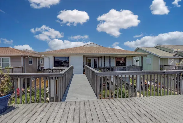 a view of a house with wooden deck