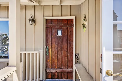 a view of a hallway with wooden floor and entryway