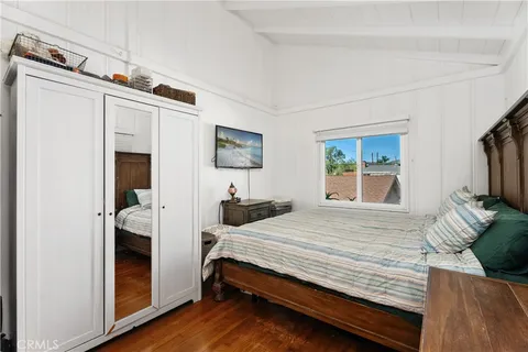 a bedroom with a bed and a flat tv screen