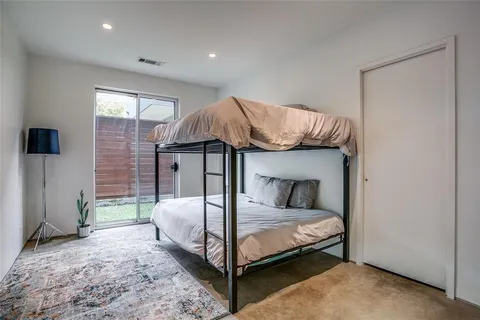 a bedroom with a bed and a mirror