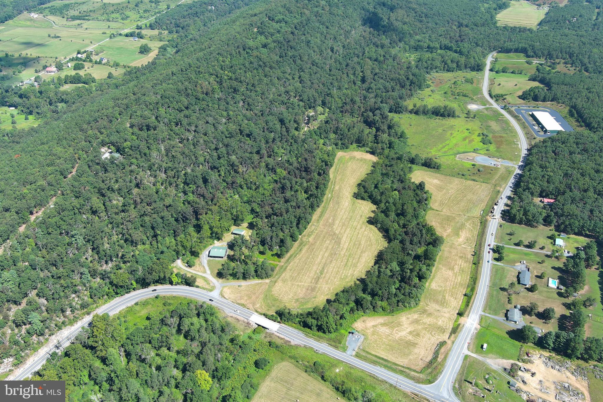 40.955 Ac Intersection Rt 50 & Smokey Hollow Road Bloomery, WV 26817 - Photo 63 of 83 an aerial view of a house with a yard and trees