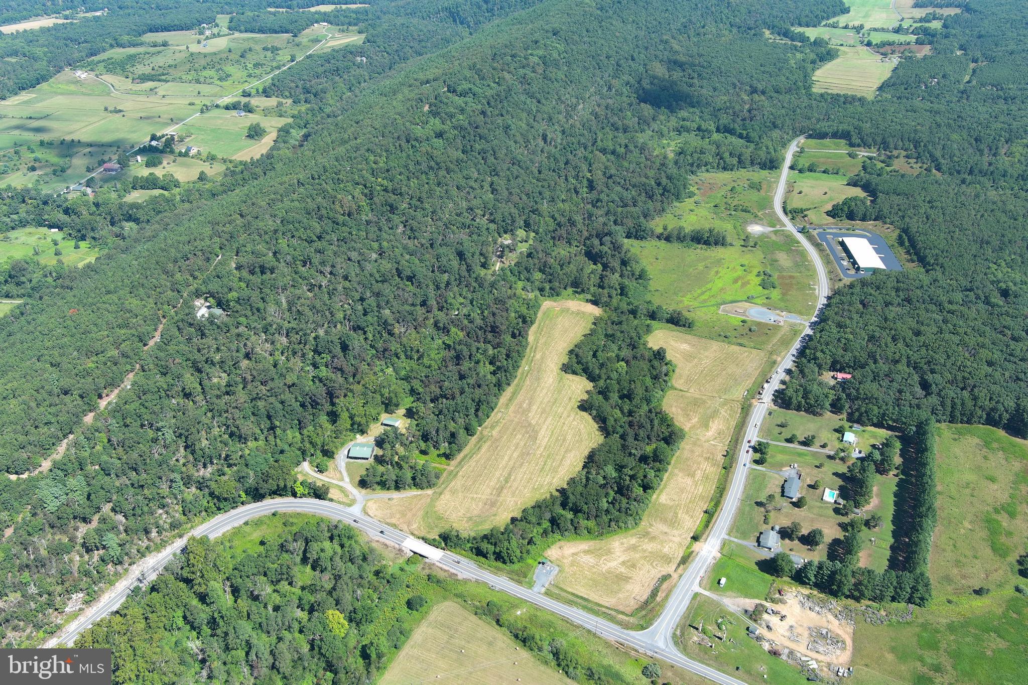 40.955 Ac Intersection Rt 50 & Smokey Hollow Road Bloomery, WV 26817 - Photo 64 of 83 an aerial view of a house with a yard and greenery
