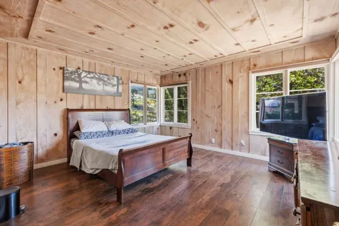 a bedroom with a large bed and a window