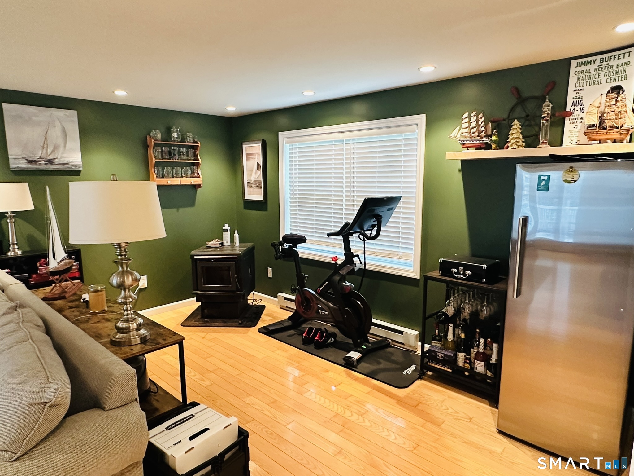 172 Old Farms Road Southington, CT 06489 - Photo 15 of 26 lower-level family room with pellet stove and access to lower deck.
