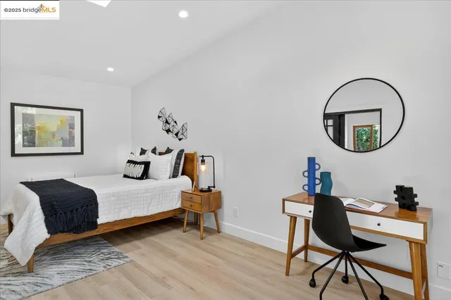 a spacious bedroom with a bed and a mirror