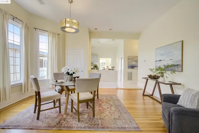 a dining room with furniture and wooden floor