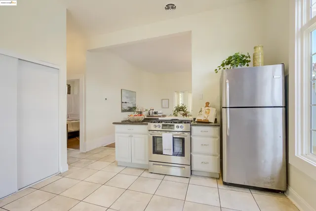 a kitchen with stainless steel appliances granite countertop a refrigerator and a stove
