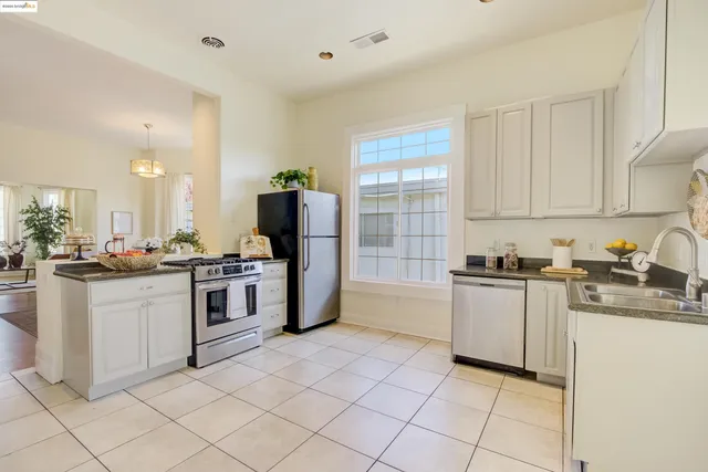 a kitchen with granite countertop cabinets and steel stainless steel appliances