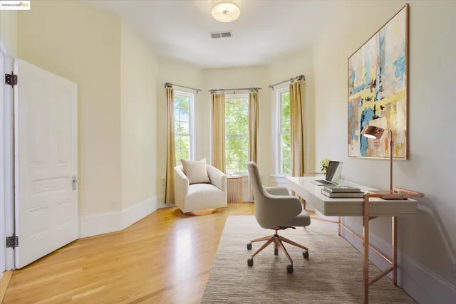 a view of a livingroom with workspace and a window