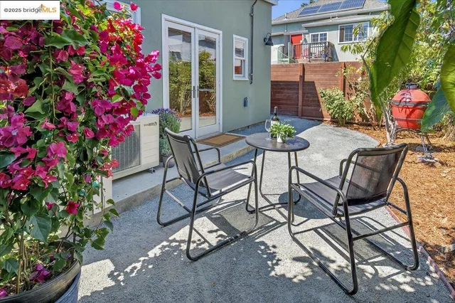 a view of a chairs and table in a backyard