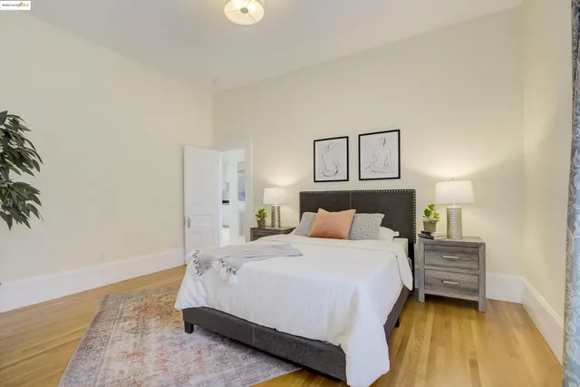 a bedroom with a bed and a painting on the wall