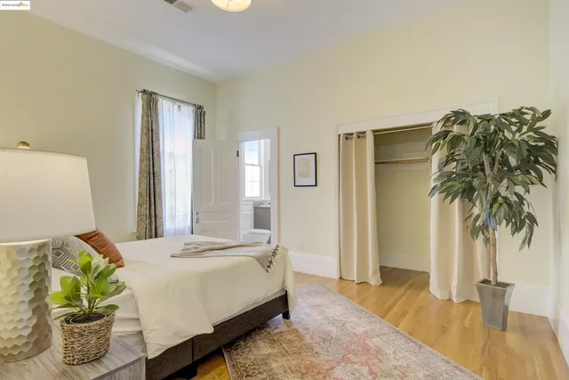 a bedroom with a bed and a potted plant
