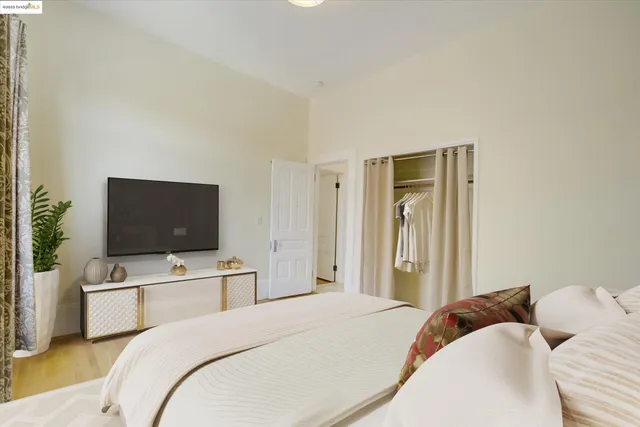 a bedroom with a bed and a flat screen tv