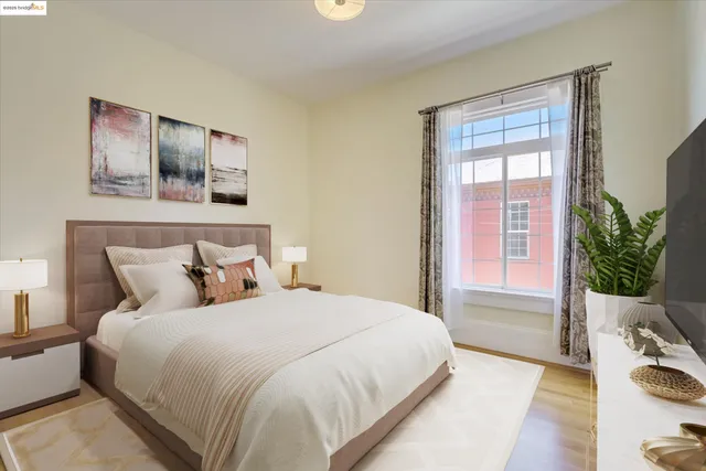 a bedroom with a bed and a window