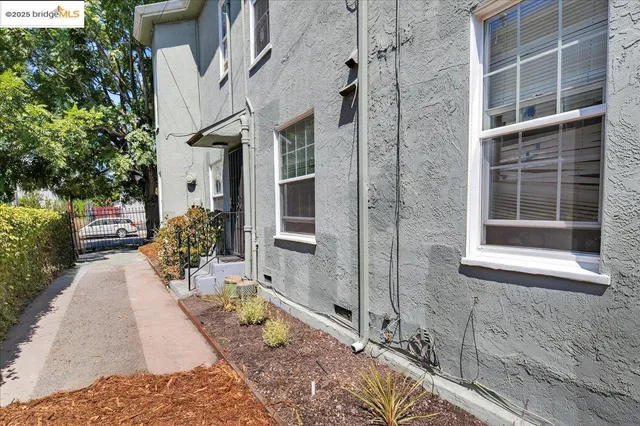 a view of a brick house with potted plants