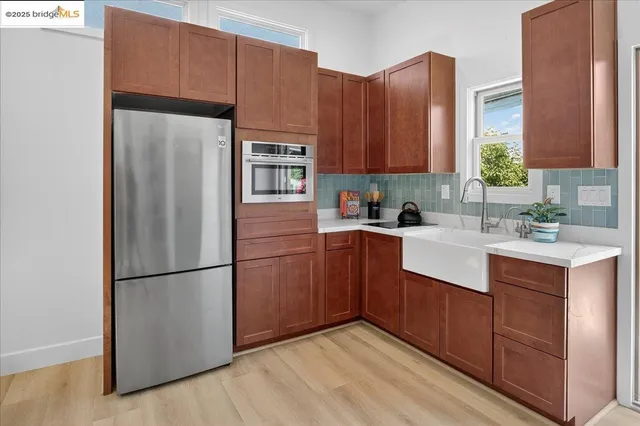 a kitchen with a sink refrigerator and cabinets