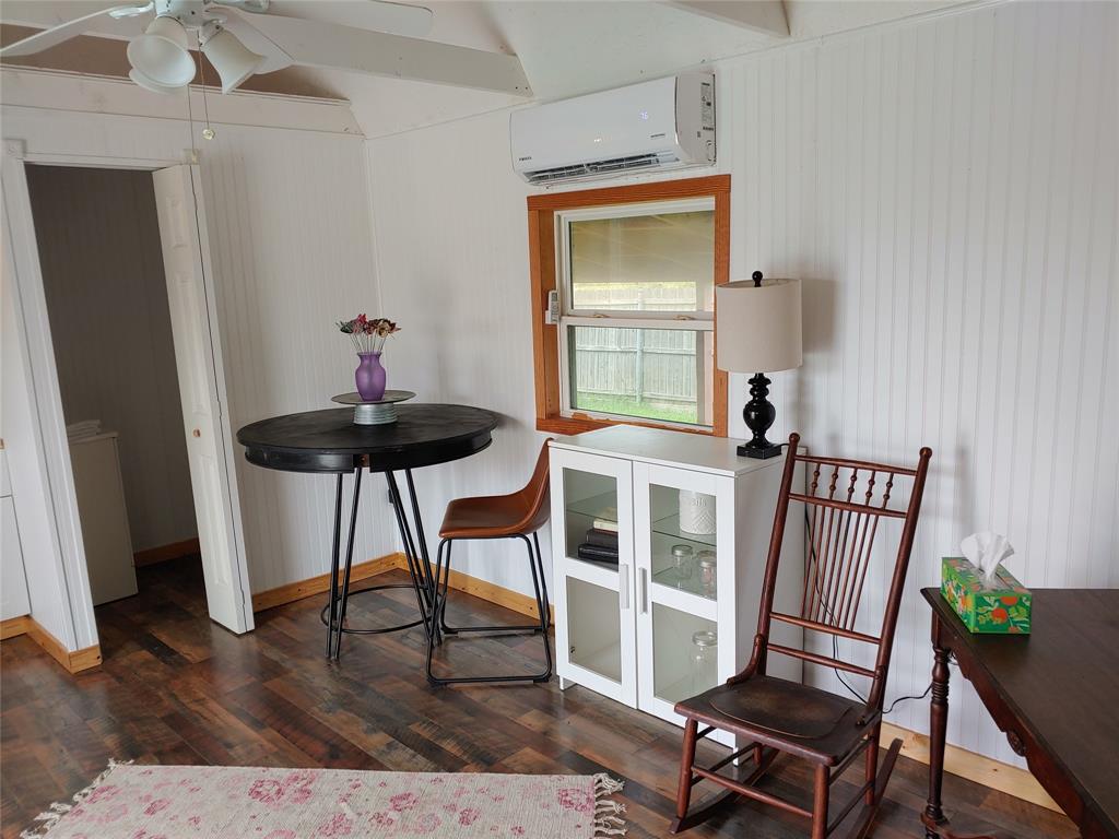 836 Airport Road Reno, TX 75462 - Photo 28 of 30 Interior space featuring wood-finish flooring, white beadboard walls, and natural wood trim around the window
