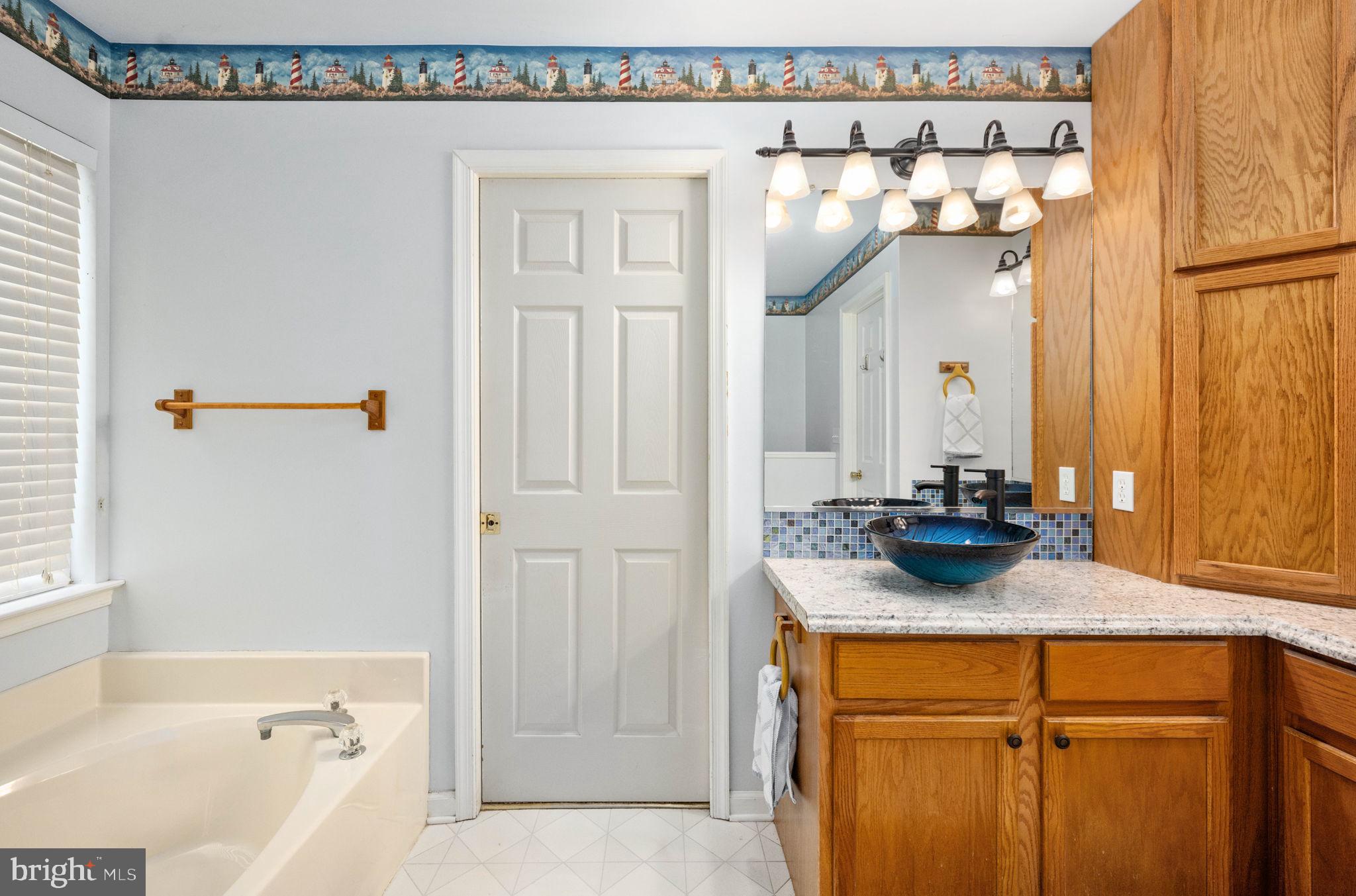 203 Fairfax Lane Locust Grove, VA 22508 - Photo 13 of 54 a bathroom with a sink and a mirror