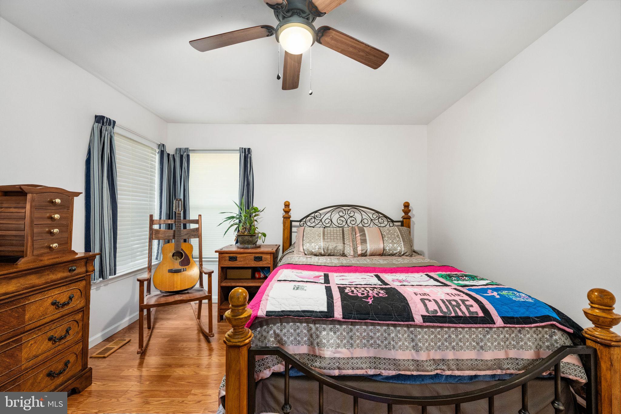 203 Fairfax Lane Locust Grove, VA 22508 - Photo 19 of 54 a bedroom with a bed a dresser and wooden floor