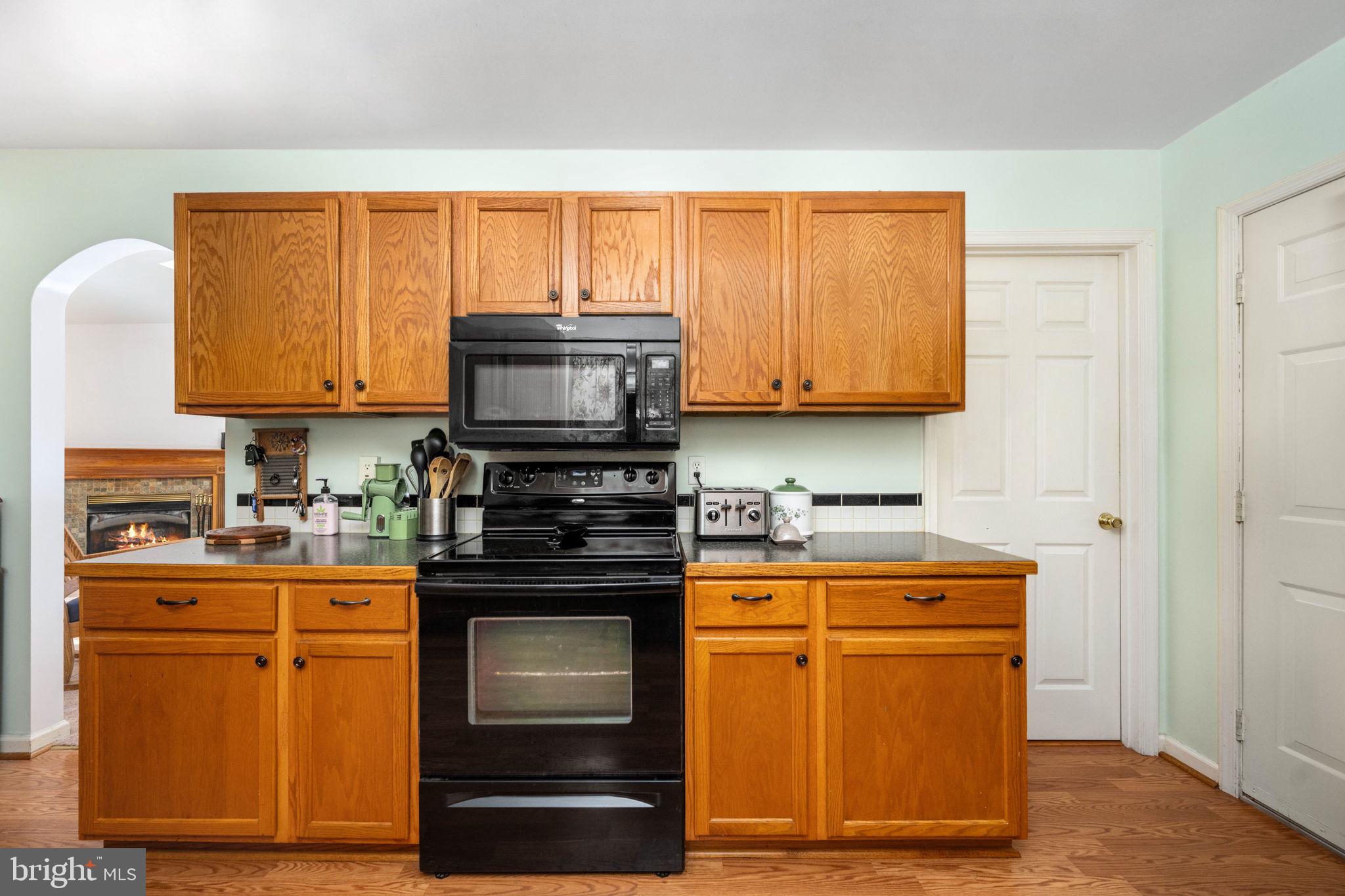 203 Fairfax Lane Locust Grove, VA 22508 - Photo 28 of 54 a kitchen with stainless steel appliances granite countertop wooden cabinets stove top oven and microwave
