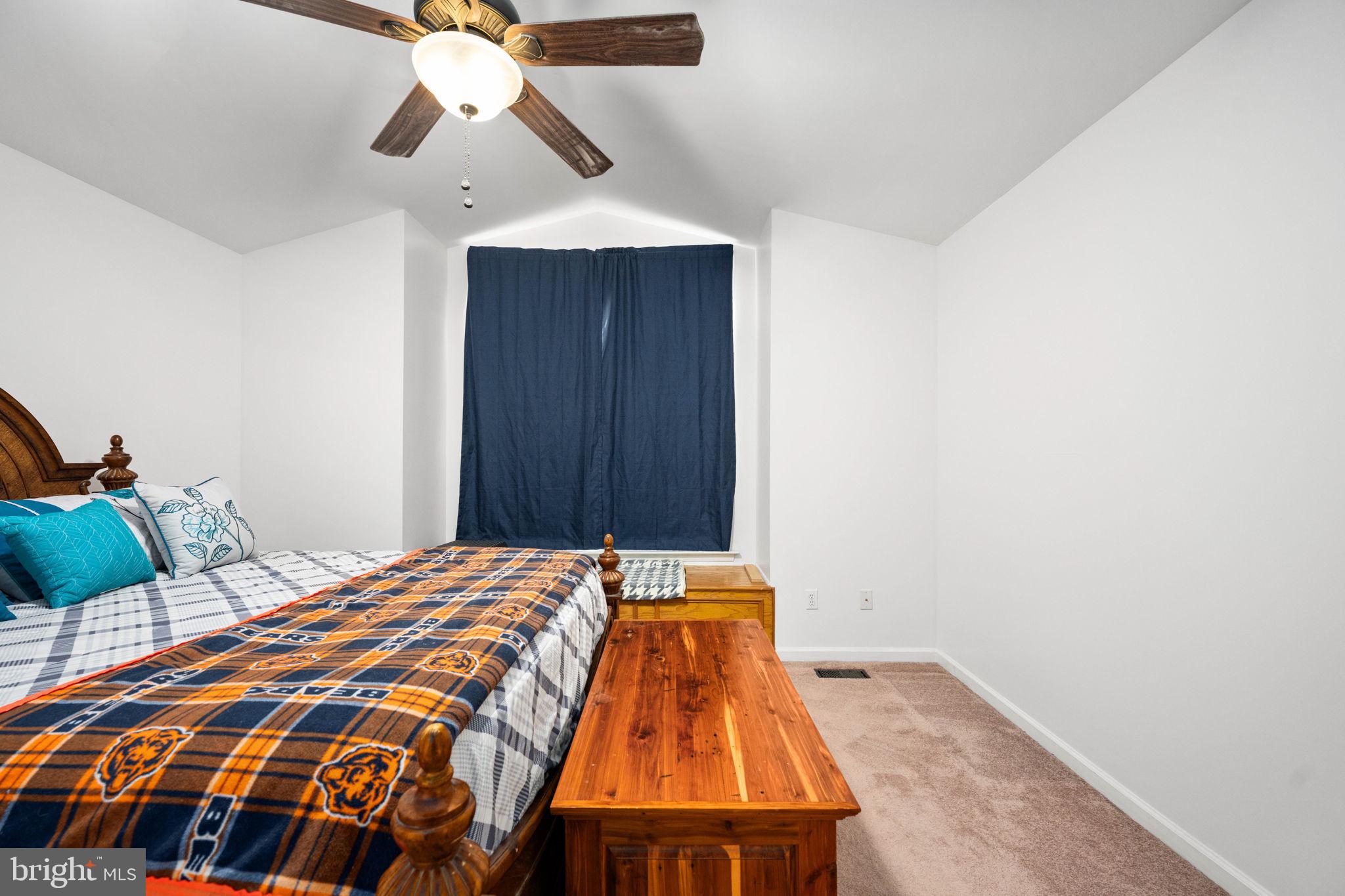 203 Fairfax Lane Locust Grove, VA 22508 - Photo 9 of 54 a bedroom with a bed and a chandelier fan