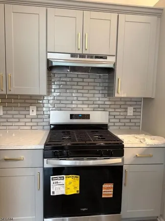 a stove top oven sitting inside of a kitchen