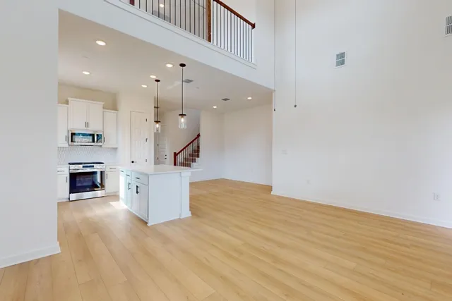 a view of kitchen and hall with wooden floor