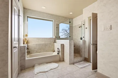 a spacious bathroom with a granite countertop sink mirror and a shower