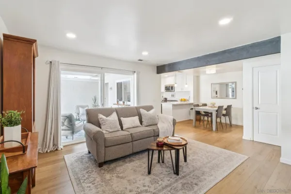 a living room with furniture wooden floor and a table