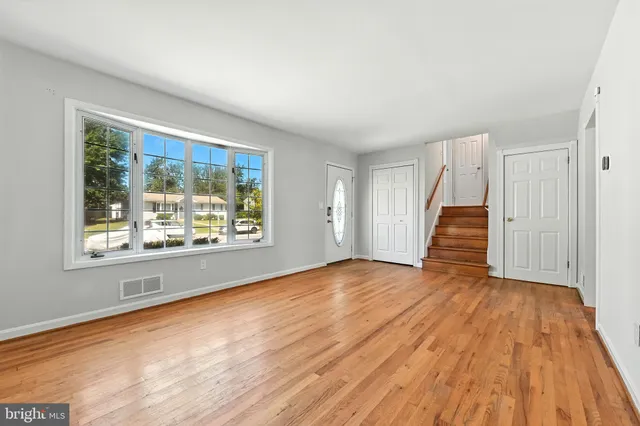 a bedroom with a large bed and a painting on the wall