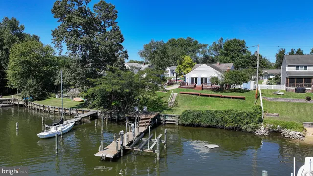a view of an ocean with boats and trees in the background