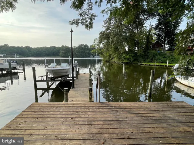 an aerial view of ocean and residential houses with outdoor space