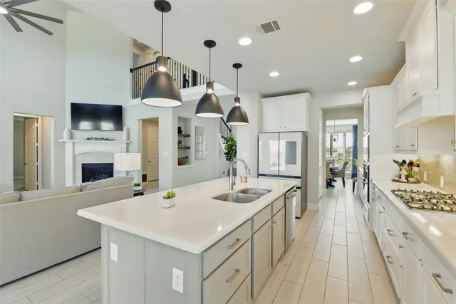 a kitchen with white cabinets and appliances