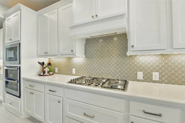 a large kitchen with a table and chairs