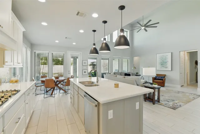 a kitchen with cabinets and chairs