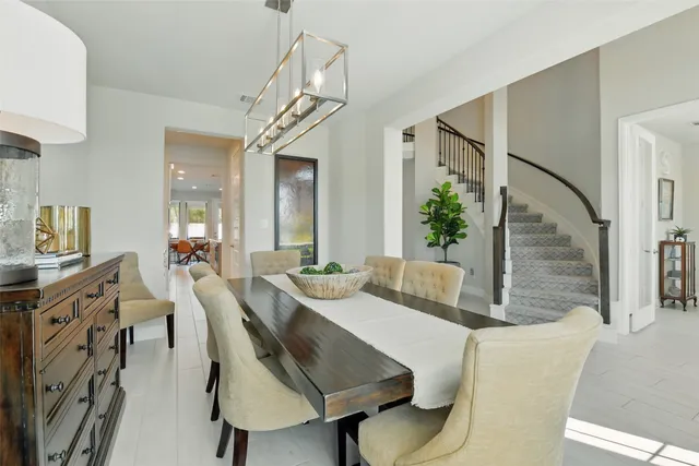 a living room with furniture a flat screen tv and kitchen view