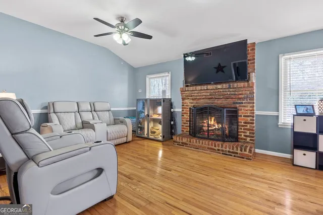 a living room with furniture fireplace and flat screen tv