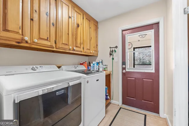 a view of room with baby crib and furniture