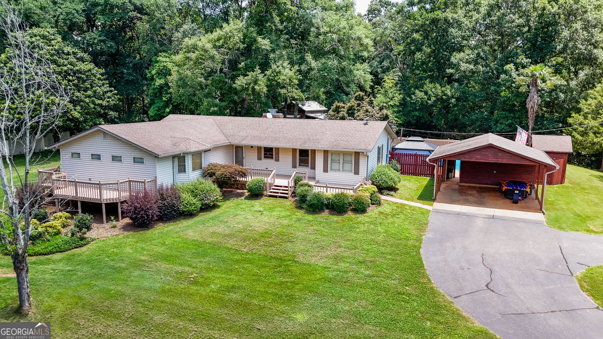 1793 Trice Cemetery Road Thomaston, GA 30286 - Photo 2 of 59 a aerial view of a house with a yard table and chairs