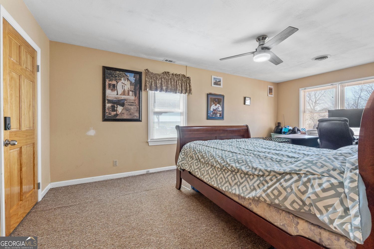 1793 Trice Cemetery Road Thomaston, GA 30286 - Photo 30 of 59 a bedroom with a large bed and a chandelier