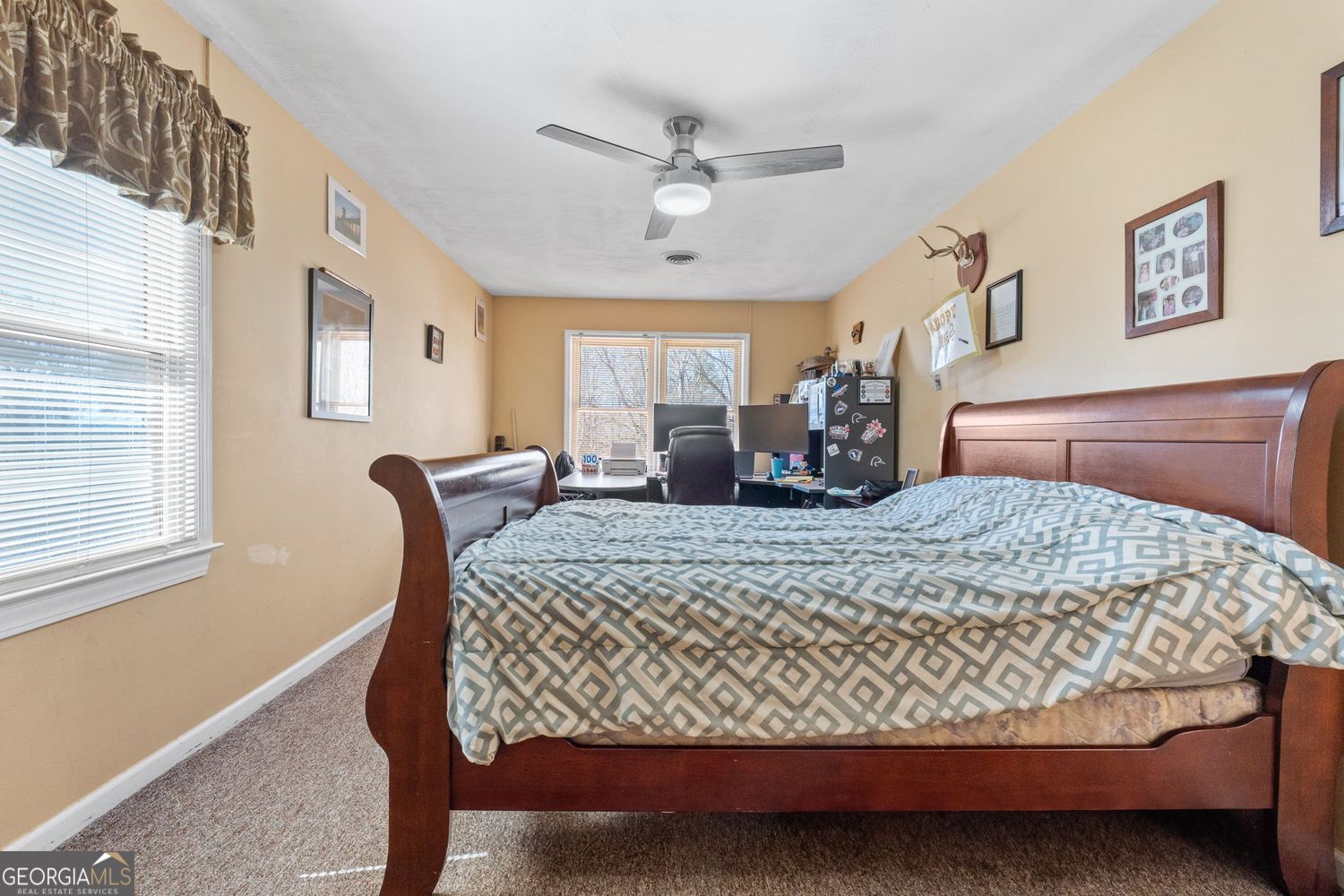 1793 Trice Cemetery Road Thomaston, GA 30286 - Photo 31 of 59 a bed sitting in a spacious bedroom next to a window and a chandelier