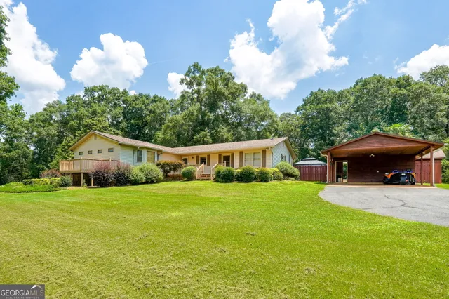 a front view of a house with a yard and seating space