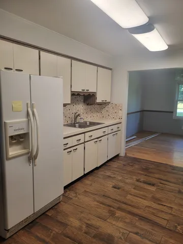 a kitchen with stainless steel appliances a refrigerator sink and cabinets