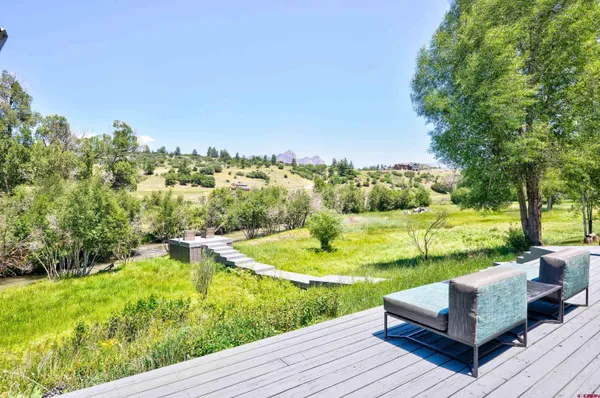 a view of a garden with lounge chair